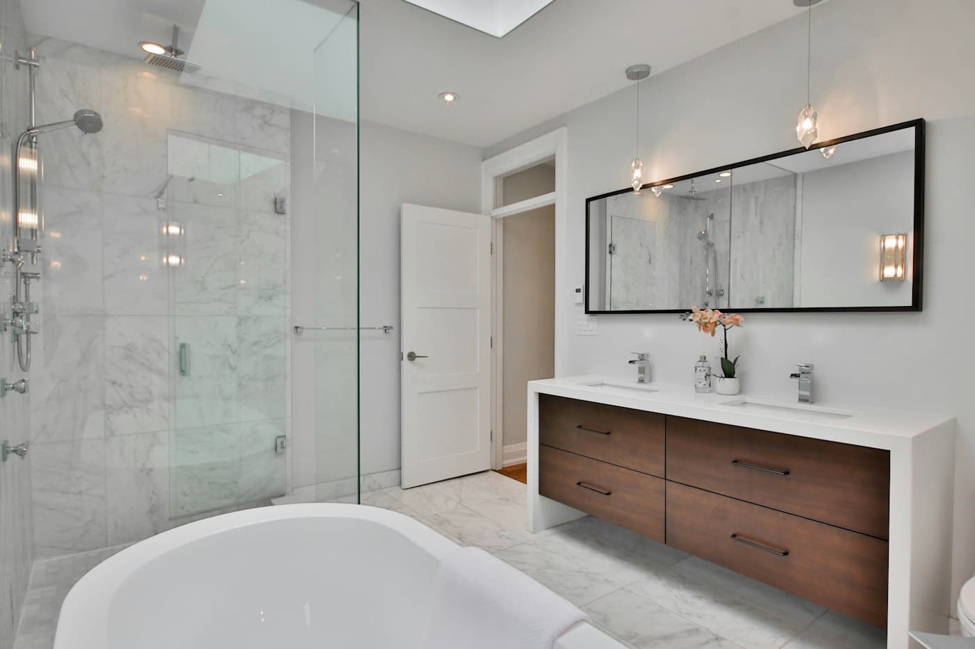 Remodeled bathroom with a walk-in shower and freestanding tub