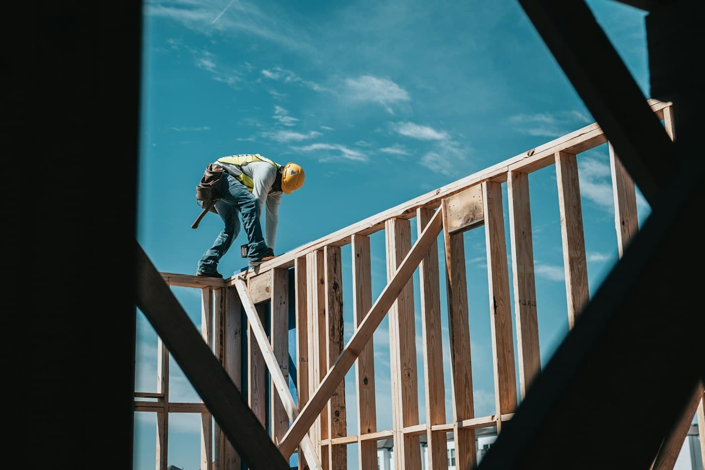 Carpenter framing the wall of a small residential structure