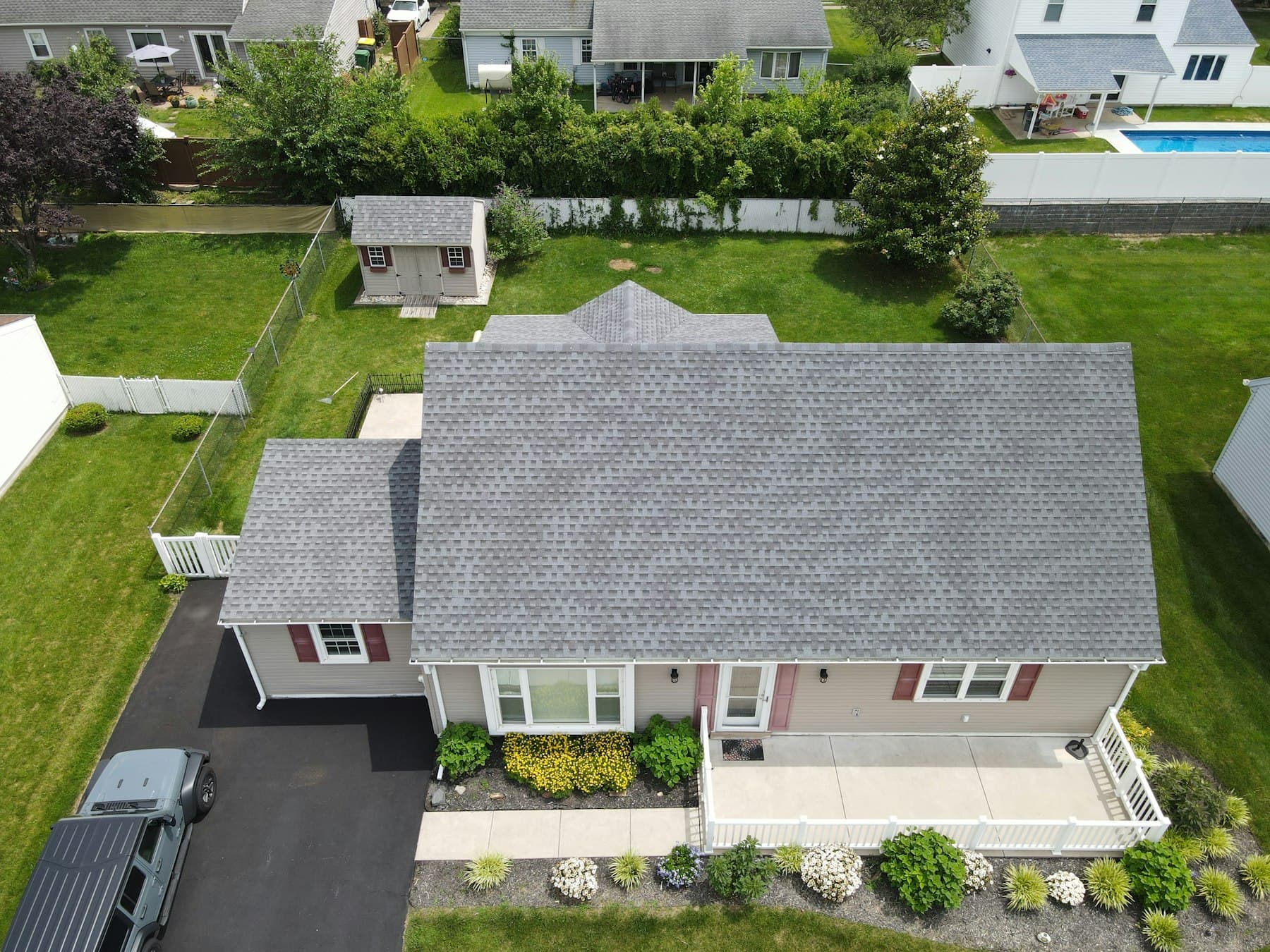 Aerial view of a single-family suburban home and yard